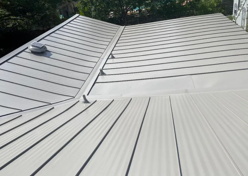 Solar attic fan installed on a metal roof for Roof Ventilation in North Madison